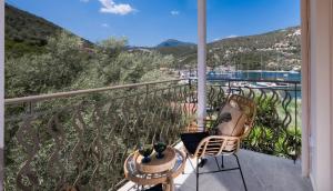 a balcony with two chairs and a table and a view at Innamorata Sivota in Sivota