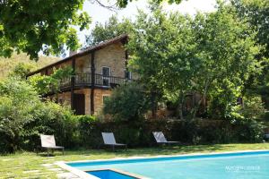 a villa with a swimming pool and a house at Moleiro da Costa Má in Sever do Vouga