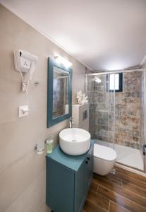 a bathroom with a sink and a toilet and a shower at Innamorata Sivota in Sivota +29 photos