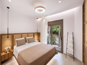 a bedroom with a large bed and a balcony at Innamorata Sivota in Sivota