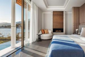 a bedroom with a bed and a view of the water at One&Only Portonovi in Herceg-Novi