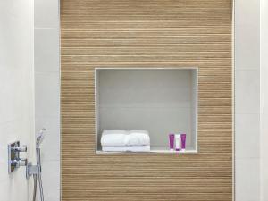 a bathroom with a mirror on a wall with a bed at Nerja Casual Rooms in Nerja +37 photos