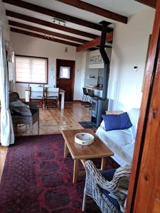 a living room with a couch and a table at "The Gatehouse", Goosebumps - Cottage in Lake Brenton on Knysna Lagoon in Brenton-on-Sea