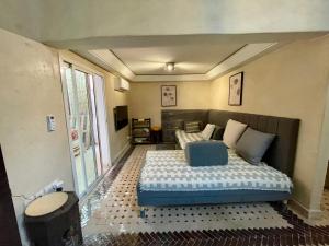 a bedroom with a bed with a blue foot board at Au Riad Des Sultans - Marrakech in Marrakech