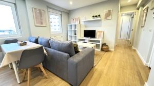 a living room with a couch and a table at Acogedor apartamento en Ronda Outeiro 210 in A Coruña