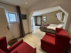 a living room with a red couch and a bed at Beach House Lagos - Beachhouselagos - Meia Praia in Lagos +47 photos