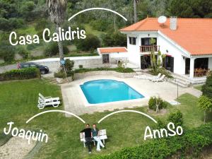 two people standing in front of a house with a pool at Casa Calidris - Bed, Wine & Breakfast in Sesimbra +93 photos