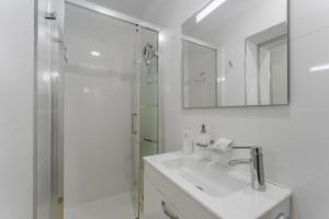 a white bathroom with a sink and a shower at Apartment in El Paso in Arona +7 photos