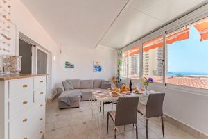 a kitchen and living room with a table and chairs at Apartment in El Paso in Arona