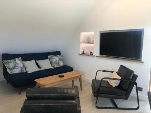 a living room with a couch and a chair at Cannister Hall Apartment, Selling, Faversham, Kent in Faversham +35 photos