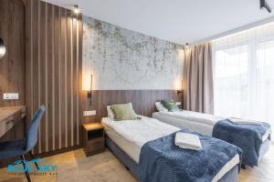 Voodi või voodid majutusasutuse Apartamenty BlueSky Kąpielowa 5C - z widokiem na góry, blisko wyciągów i szlaków turystycznych toas