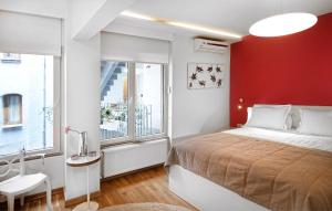 a bedroom with a bed and a red wall at Nuru Ziya Residences in Istanbul