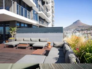 a patio with couches and tables and a building at 2505 Studio in Central Cape Town, Wi-Fi, pool, free parking in Cape Town