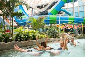 a group of children in the water at a water park at 2 Lake Cabins Poolhottub Game Room & Courts in Highland Lake