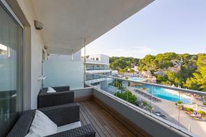 an apartment balcony with a view of a pool at ARTIEM Audax - Adults Only in Cala Galdana