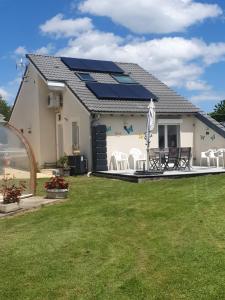 a house with solar panels on the roof at gîte m et m in Nébouzat
