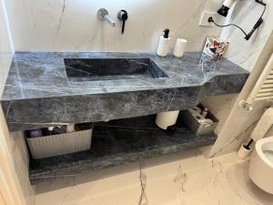 a bathroom with a marble sink and a toilet at Residence du Casino in Menton +31 photos