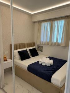 a bedroom with a large bed with two pillows at Residence du Casino in Menton