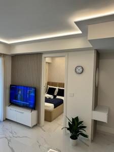 a bedroom with a bed and a tv in a room at Residence du Casino in Menton