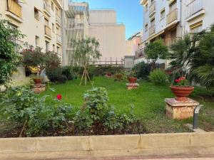 a garden with flowers and plants in a building at Residence du Casino in Menton