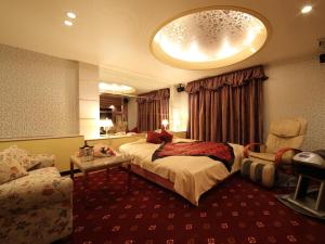 a hotel room with a bed and a couch at Hotel La Siesta (Adult Only) in Kyoto