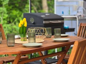 a picnic table with plates and yellow flowers on it at Ах, морето !!! in Tsarevo
