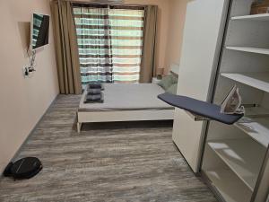 a small room with a bed and a window at Ах, морето !!! in Tsarevo