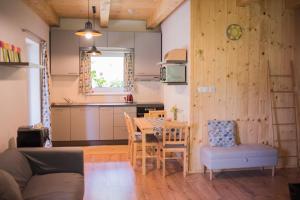 a kitchen and dining room with a table and chairs at Lesná Kokava in Kokava na Rimavica