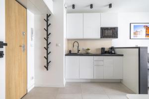 Kuchyňa alebo kuchynka v ubytovaní Apartamenty Central Gdańsk Q4Apartments