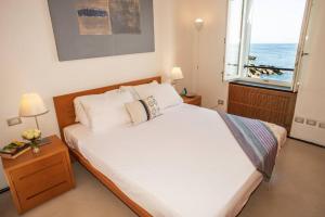 A bed or beds in a room at Carattino 12 Idyllic Seafront Retreat