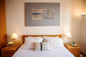 A bed or beds in a room at Carattino 12 Idyllic Seafront Retreat