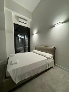 a bedroom with a large bed in a room at Effealatapartments - EdenLoft in Senigallia