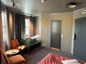 a hotel room with a bed and a chair at Grong Hotell in Grong