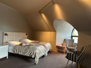 a bedroom with a bed and a chair in a room at Grong Hotell in Grong