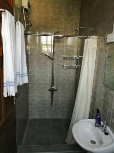 a bathroom with a shower and a sink at GUSSYS Homes in Cape Coast +35 photos
