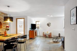 a living room and dining room with a table and chairs at Felicitas in Tann
