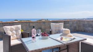 a table with a bottle of wine and a bowl of fruit at Casa Maria de Velez Almayate Alto by Ruralidays in Almayate Alto