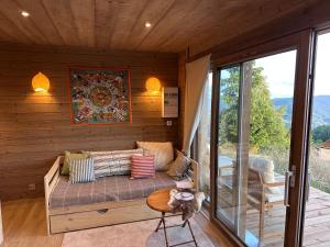 a living room with a couch and a table at Gîte la Tanière de L'Ourse in Hohrod +5 photos