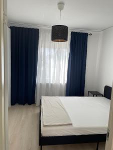 a bedroom with a bed and blue curtains at Prisvärd & rymlig lgh nära ALV in Vimmerby