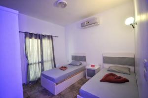 a bedroom with two beds and a window at Elite Residence Dahab in Dahab