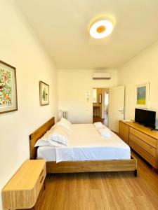 a bedroom with two beds and a flat screen tv at Doria home-Saint Peter's View in Rome +5 photos