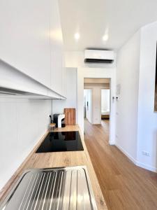 a living room with white walls and wood floors at Doria home-Saint Peter's View in Rome