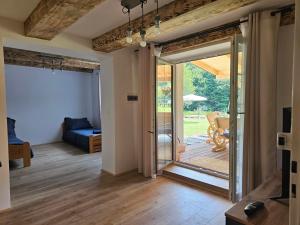 a living room with a sliding glass door to a patio at Przy potoku in Średnia Wieś