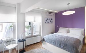 a bedroom with a bed and a purple wall at Nuru Ziya Residences in Istanbul