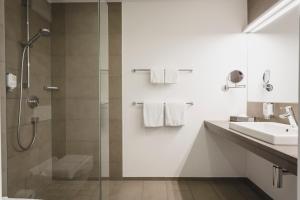 a bathroom with a shower and a sink at Sternen Hotel Wolfurt in Bregenz