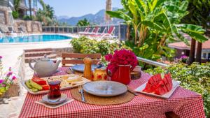 a table with food on a red and white table cloth at Selimiye Meltem's in Marmaris