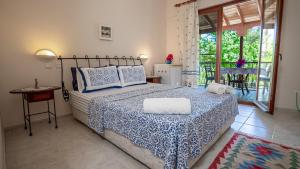 a bedroom with a bed with a blue and white bedspread at Selimiye Meltem's in Marmaris +88 photos