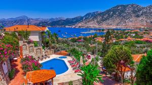 arial view of a resort with a pool and a lake at Selimiye Meltem's in Marmaris