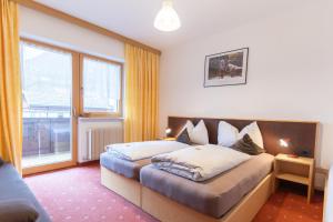 Postel nebo postele na pokoji v ubytování Hotel Martellerhof