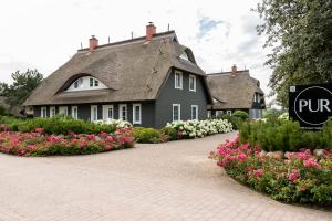 a large house with flowers in front of it at Pur A4 in Wustrow